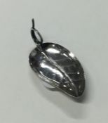 A Victorian silver leaf shaped caddy spoon with en