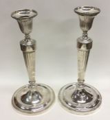A good pair of George III cast silver candlesticks
