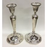 A good pair of George III cast silver candlesticks