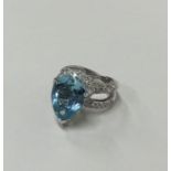 A large diamond and aquamarine pear shaped ring in