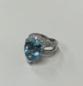 A large diamond and aquamarine pear shaped ring in