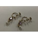 A pair of amethyst and pearl drop earrings set in