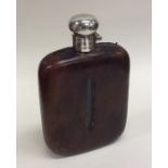 A large silver and leather mounted hip flask with