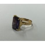 An amethyst single stone ring in gold claw mount.