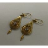 A pair of Antique high carat gold drop earrings en