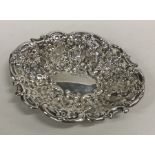 An attractive silver sweet dish embossed with flow