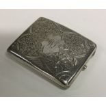 An attractively engraved silver cigarette case. Bi