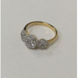 An 18 carat gold triple diamond cluster ring. Appr