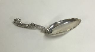 A Continental silver fancy caddy spoon with scroll