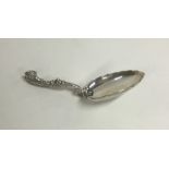 A Continental silver fancy caddy spoon with scroll