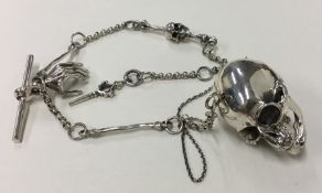 A novelty silver pendant in the form of a skull on