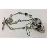 A novelty silver pendant in the form of a skull on