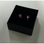 A pair of single stone tourmaline ear studs contai