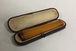 An amber mounted cigarette holder in case. Approx.