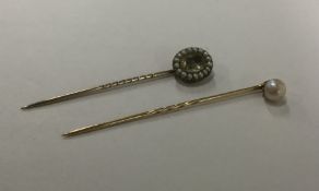 An Antique pearl mounted stick pin together with a