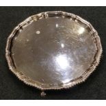 A heavy Edwardian silver salver with gadroon rim.