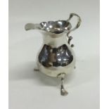A Georgian circular silver cream jug with card cut