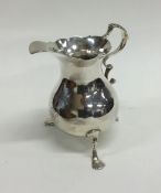 A Georgian circular silver cream jug with card cut