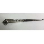 An unusual silver button hook mounted with a lion.