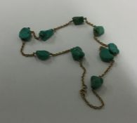 A turquoise and gold mounted necklace with ring cl