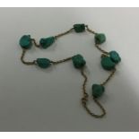 A turquoise and gold mounted necklace with ring cl