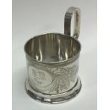 A Russian silver glass holder finely engraved with