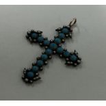 An unusual pearl mounted cross with loop top set i