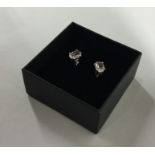 A pair of single stone ear studs in four claw moun