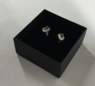 A pair of single stone ear studs in four claw moun