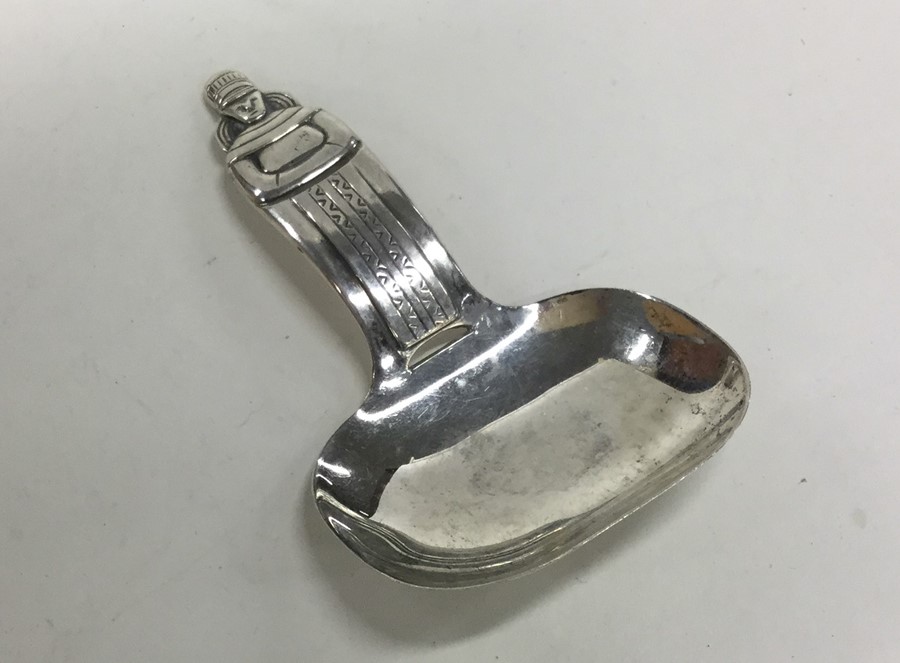 A large Continental silver caddy spoon of tapering