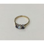 A sapphire and opal three stone ring in claw mount