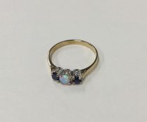 A sapphire and opal three stone ring in claw mount