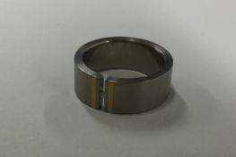 An unusual titanium and diamond set gent's ring. A