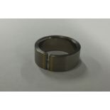 An unusual titanium and diamond set gent's ring. A