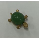 A carved jade brooch in the form of a tortoise in