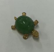 A carved jade brooch in the form of a tortoise in