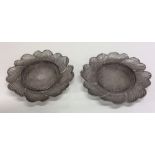 A pair of silver filigree dishes of circular form.