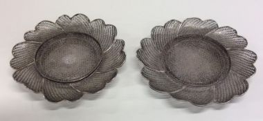 A pair of silver filigree dishes of circular form.