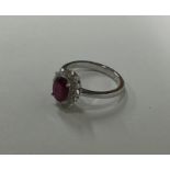 An attractive ruby and diamond oval daisy head clu