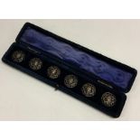 A cased set of six silver pierced buttons. Est. £2