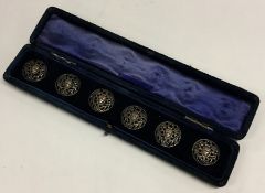 A cased set of six silver pierced buttons. Est. £2