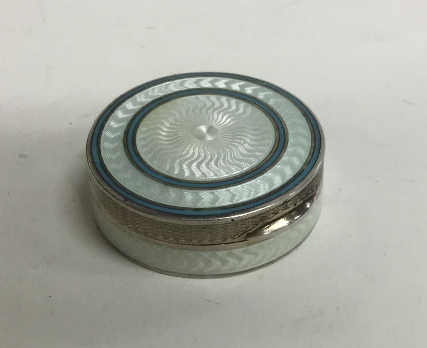 A circular French silver and enamelled pill box wi