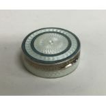 A circular French silver and enamelled pill box wi