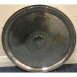 A circular silver plated salver. Est. £20 - £30.
