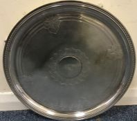 A circular silver plated salver. Est. £20 - £30.