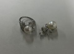 An attractive pearl and diamond cluster ring set w