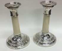 A pair of early Edwardian tapering silver candlest