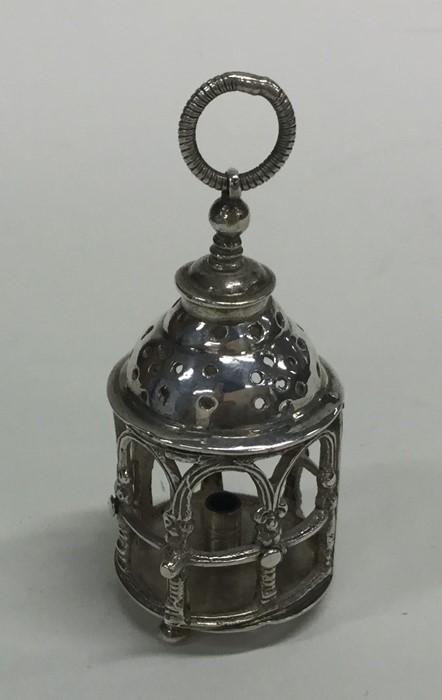 An unusual miniature silver candle holder in the f