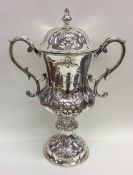 A tall Indian Colonial embossed silver cup and cov