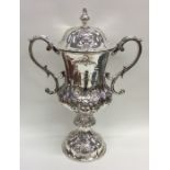 A tall Indian Colonial embossed silver cup and cov